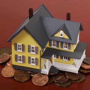 toy house on top of coins toy house on top of coins